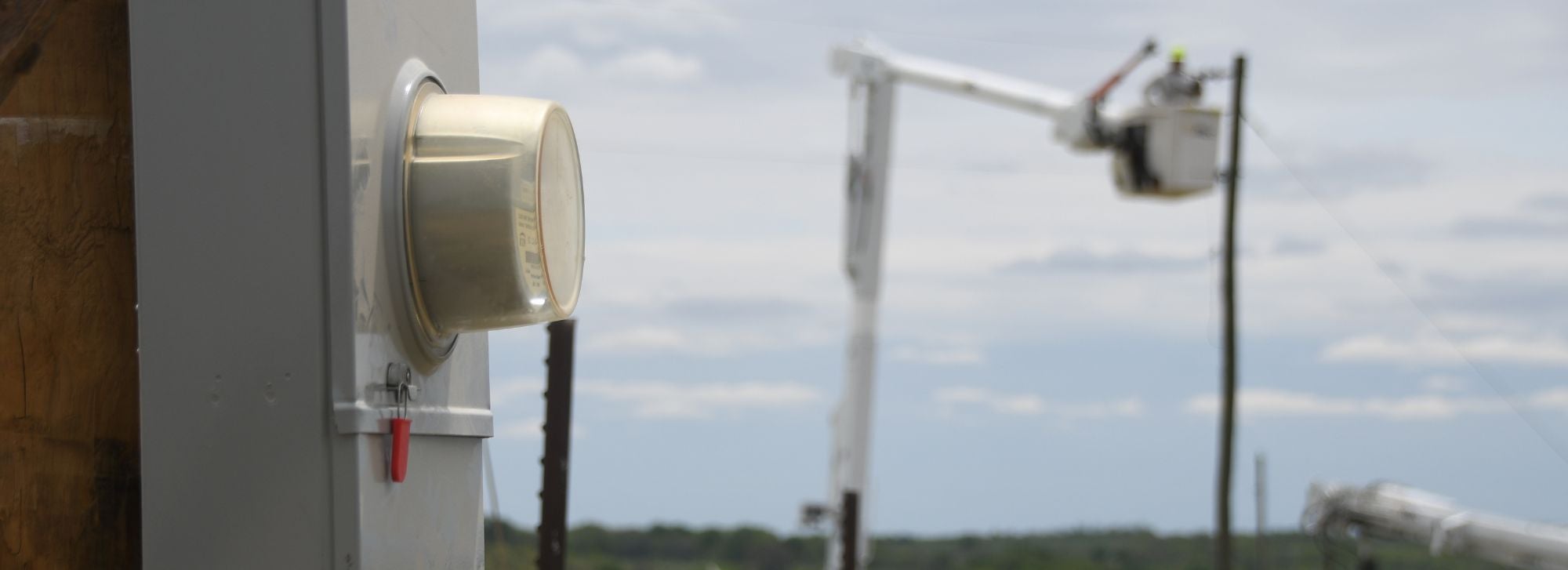 Meter with lineman in the background