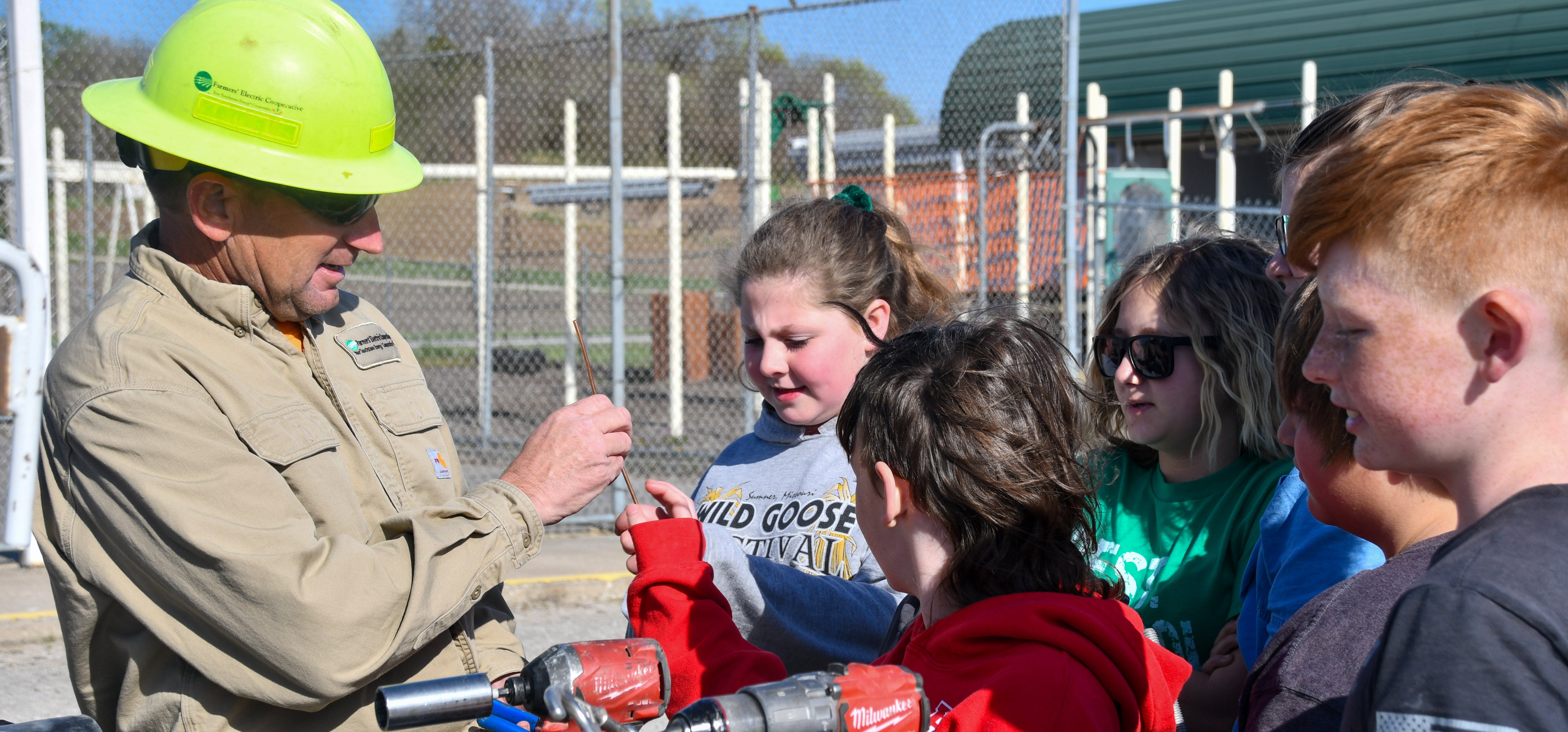 Lineman showing T-A school some equipment they use