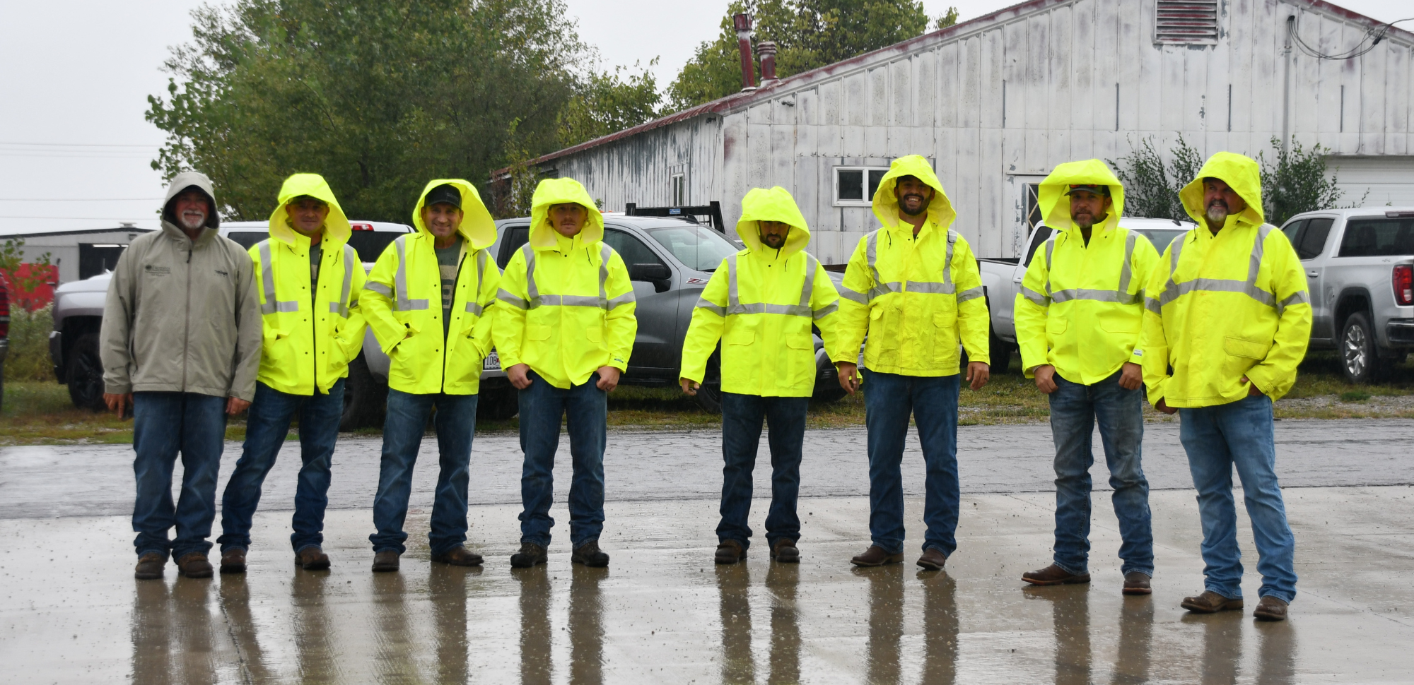 Employees in raincoats at 87th Annual Meeting